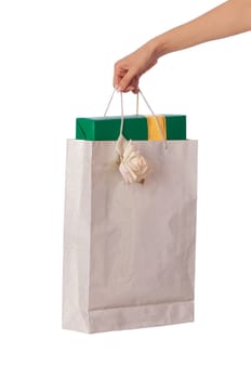 Paper bag with a green box and with a yellow ribbon from the supermarket