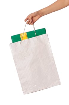 Paper bag with a green box and with a yellow ribbon from the supermarket