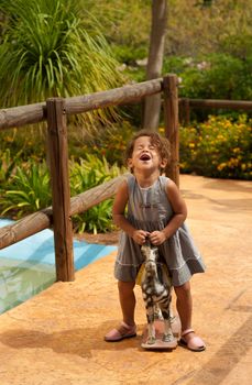 Cute Hispanic girl discovering how much fun old toys are