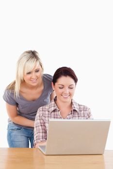 Portrait of Charming women with a laptop in a studio