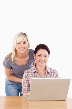 Portrait of cute women with a laptop in a studio