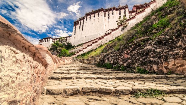 Potala temple view with blue sky and white clouds and stairs, Lhasa, Tibet