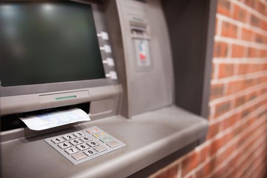 Close up of an ATM with a twenty euros notes in it