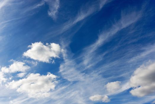 Blue sky and fluffy clouds background