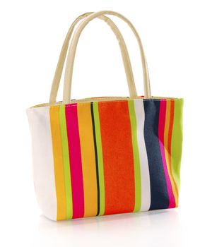 colorful canvas hand bag with reflection on white background