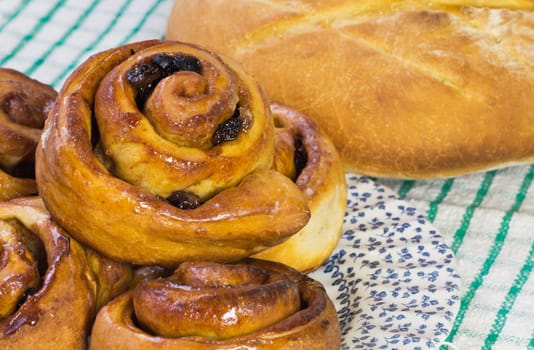A plate of Chelsea buns and fresh bread