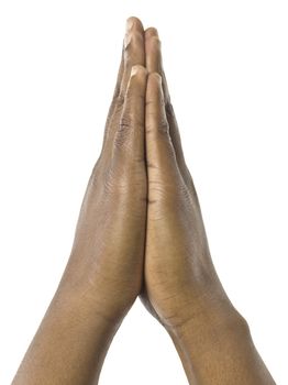 Close-up image of a praying hand against the white surface