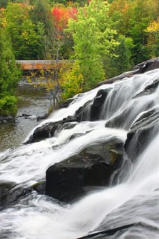 Autumn foliage surrounds the cascading waters of Bond Falls in northern Michigan.