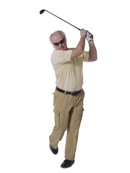 Old male golfer swinging his golf club