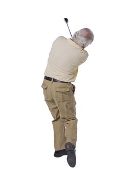 Back shot of an old male golfer swinging his golf club