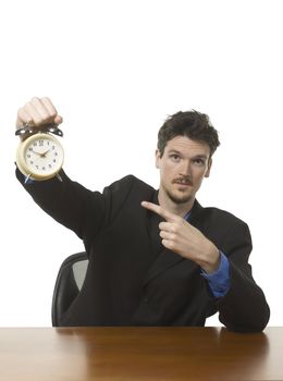Caucasian businessman showing an alarm clock