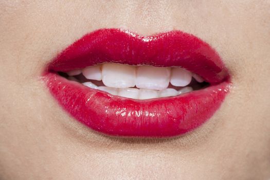 Close-up image of shiny red lips of a woman 