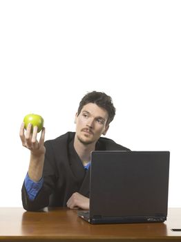 Portrait of businessman holding a green apple against white background 