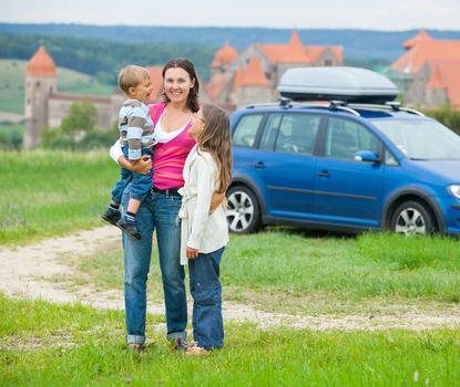 Travelers. Happy famyli of three on a tour of European medieval castles.