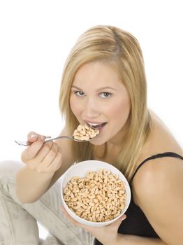 Portrait of a pretty Caucasian woman eating cereals