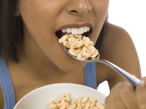 Closed up image of a black american female eating cereals