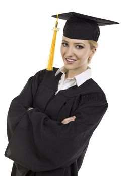 Close-up image of a smiling female student wearing graduation gown with arm crossed 