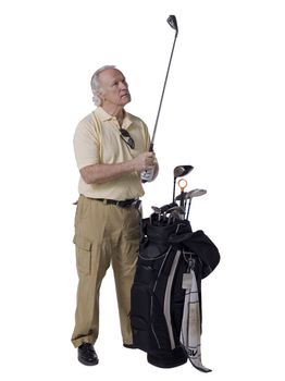 Portrait of an old man holding golf club with a bag beside him