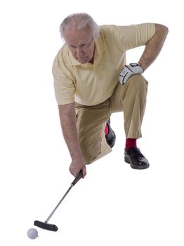 Close-up image of a senior man pushing the golf ball on a white background