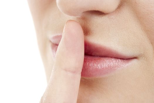 Cropped image of a woman with a silence gesture over the white background