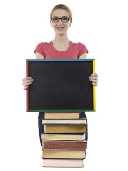 Pretty school girl with books and empty black board