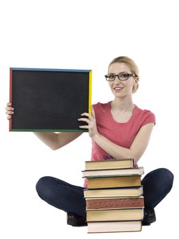 Close-up image a happy student holding black empty board sitting on a white surface