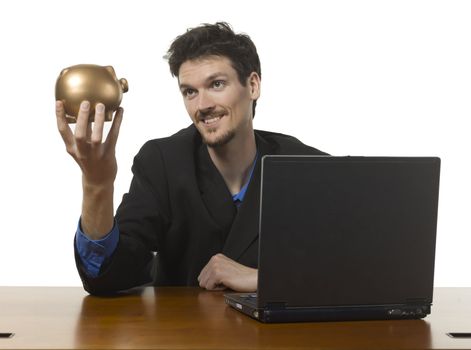 Close-up image of a happy businessman holding golden piggy bank against the white background