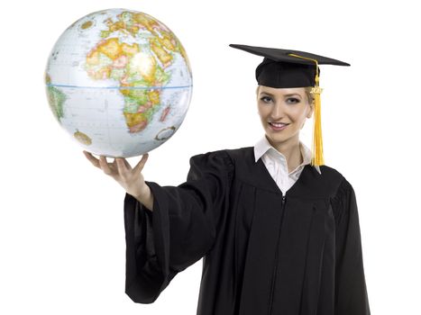 Portrait of graduating female student holding world globe against white background