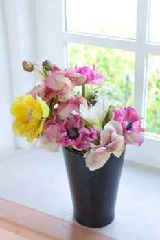 black vase and flower on the white table