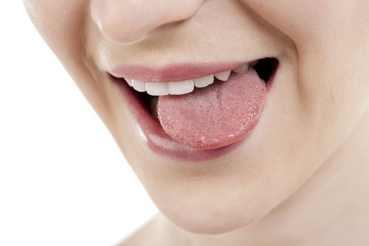 Close-up image of a teasing woman with tongue out against the white background