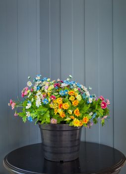 black vase and flower on the wood table
