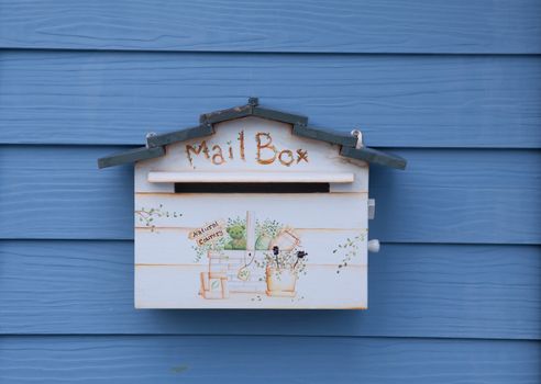 Wood mail box on wood blue wall background