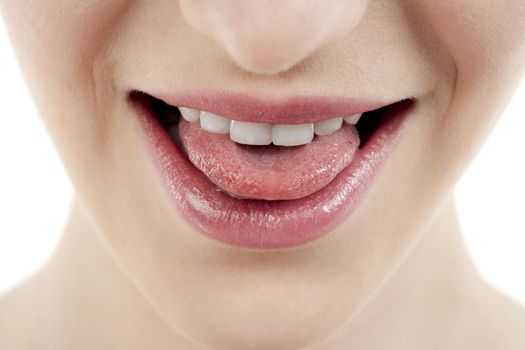 Close-up image of a woman with tongue out isolated on a white surface
