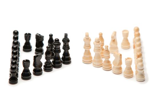 Dark and white pieces of chess on a white background