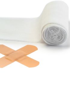 Band-aid and tensor bandage on a white background