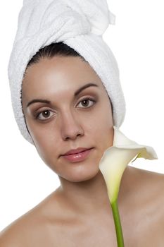 Topless spa woman holding a lily flower