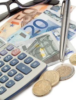 Cash, coins, pen, glasses and pocket calculator on a white background