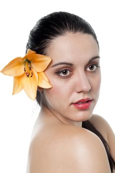 Close-up image of a beautiful lady with an orange flower on ear 