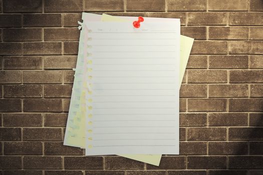 paper sheet and red pin on dark brickwall