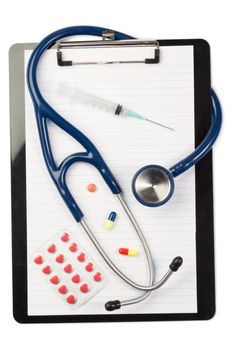 Note pad and stethoscope with color capsules and blister strip on a white background