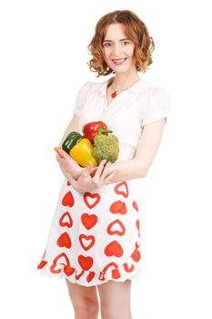 Young beautiful woman holding a bunch of fresh vegetables, white background