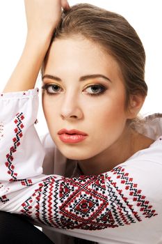 Portrait of a young beautiful woman in national Slavic clothing