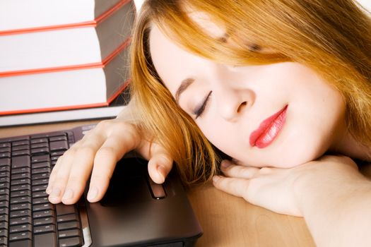 Young woman sleeping at her workplace