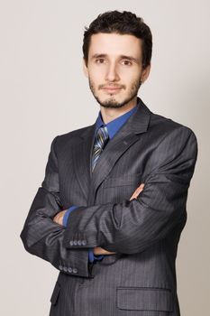 Young handsome businessman studio portrait, neutral background