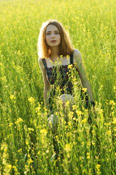 Young beautiful woman in a field
