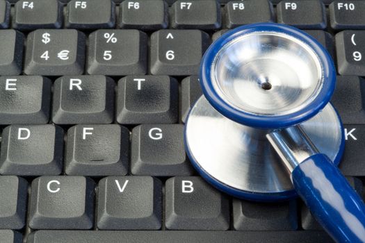 Blue stethoscope on keyboard
