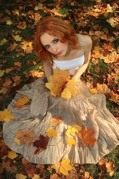 Romantic photo of a young woman in yellow leaves