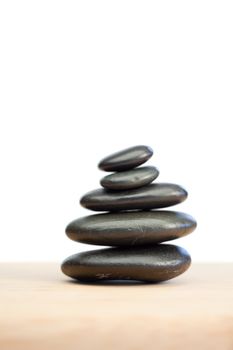 Piled up pebbles on a white and brown background