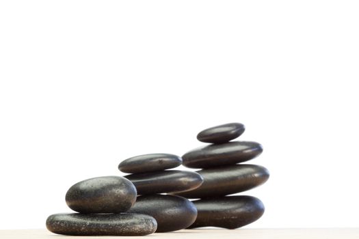 Differents piled up pebbles on a white background