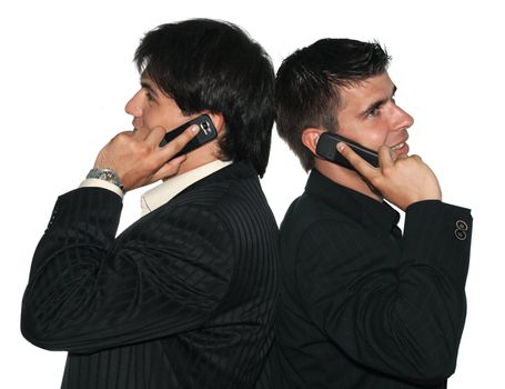 Two young businessmen talking on their mobile phones